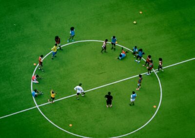 Youth soccer players practicing drills on a green field