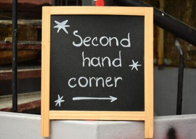 Black chalkboard sign reads "second hand corner"